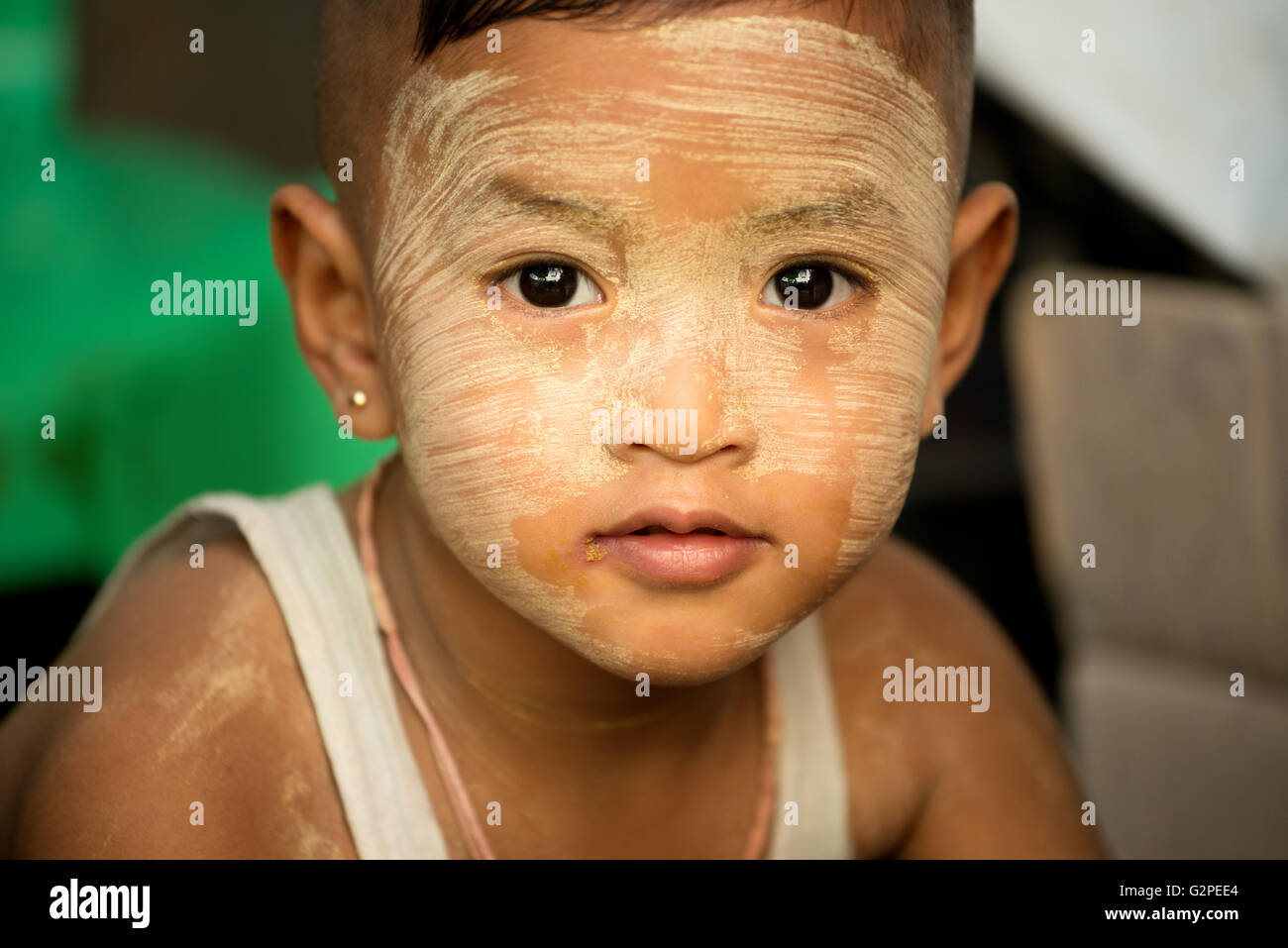 Young boy with thanaka cream on his face, Yangon, Myanmar Stock Photo