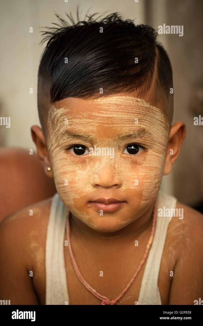 Young boy with thanaka cream on his face, Yangon, Myanmar Stock Photo