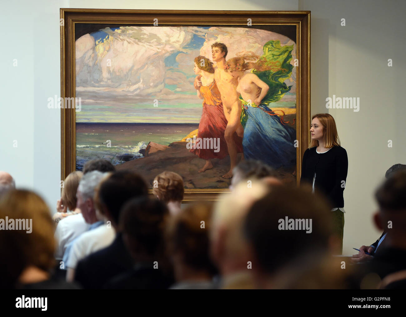 Berlin, Germany. 01st June, 2016. An employee of the Villa Grisebach at their spring auction presents the work 'Fruehlingssturm' (LT. Spring Storm) by Ludwig von Hofmann in Berlin, Germany, 01 June 2016. The painting was part of collection of publisher Rudolf Mosse. Photo: BRITTA PEDERSEN/dpa/Alamy Live News Stock Photo