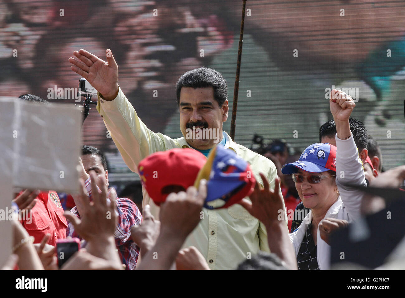 Caracas, Venezuela. 1st June, 2016. Venezuelan President Nicolas Maduro (C) reacts during a rally in Caracas, Venezuela, on June 1, 2016. Venezuelan President Nicolas Maduro urged on Wednesday the youth and the progressive movements of the country to keep on with permanent campaign against the intention of the 'empire of intervene' in the Caribbean country. Credit:  Boris Vergara/Xinhua/Alamy Live News Stock Photo