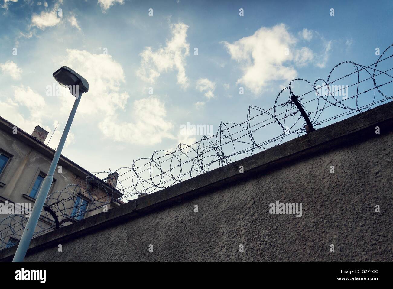 Filtered vintage picture of barbed wire prison fence detail Stock Photo