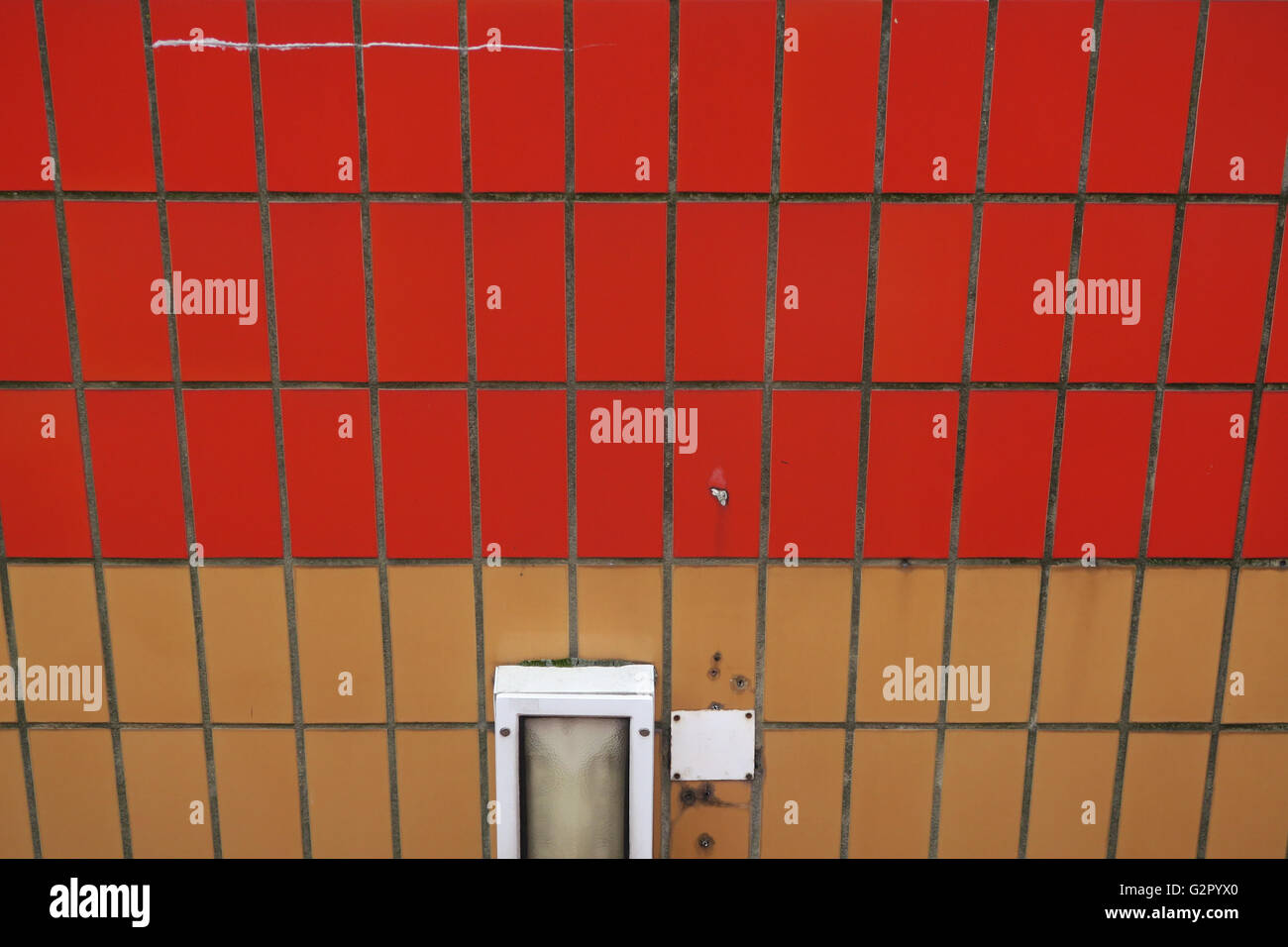 colourful wall with tiles and light, red and orange at Pimlico tube station Stock Photo