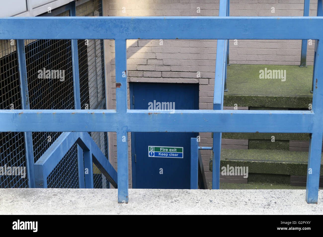 blue railings, fire door, stairs Stock Photo