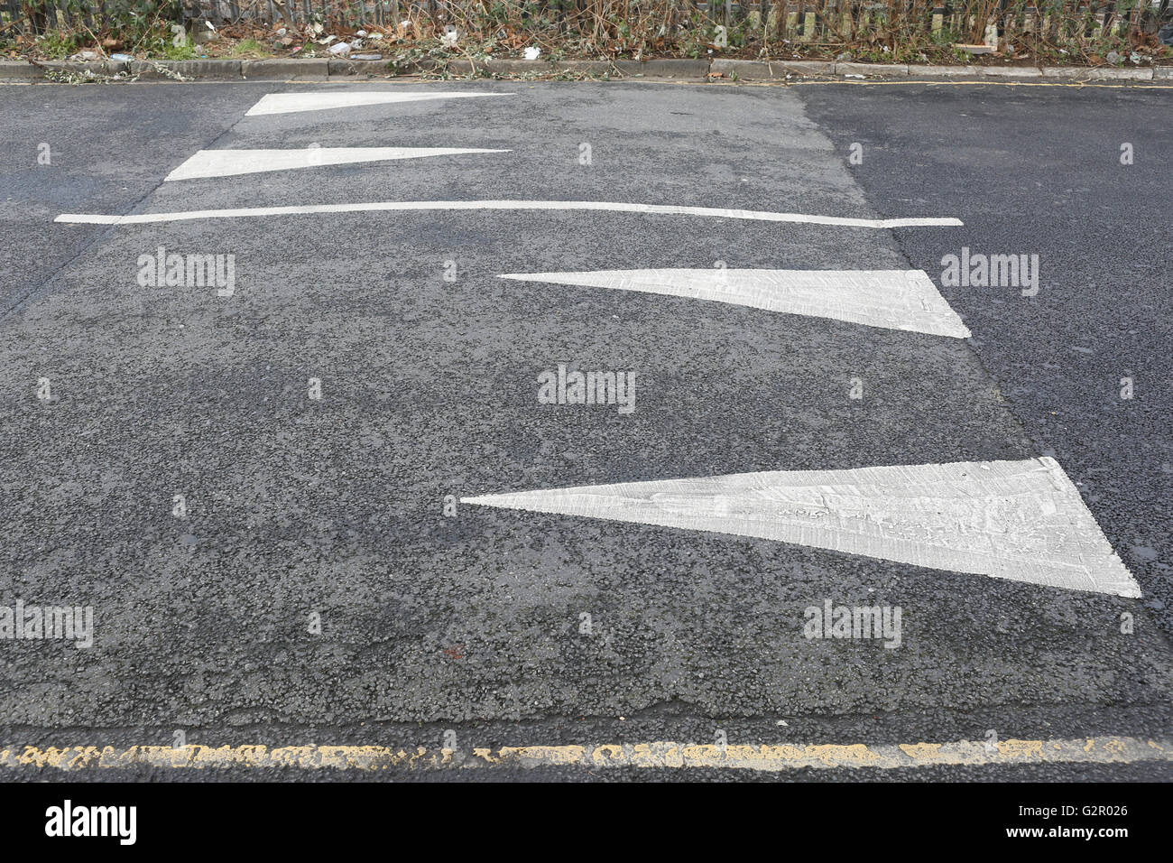Speed bump with arrows, road markings Stock Photo