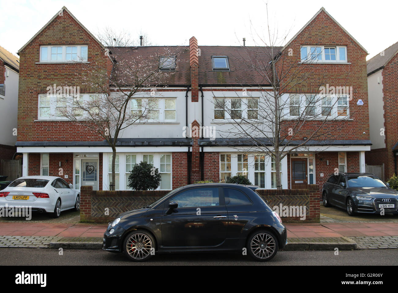 cars parked, in drives outside semi-detached houses Stock Photo