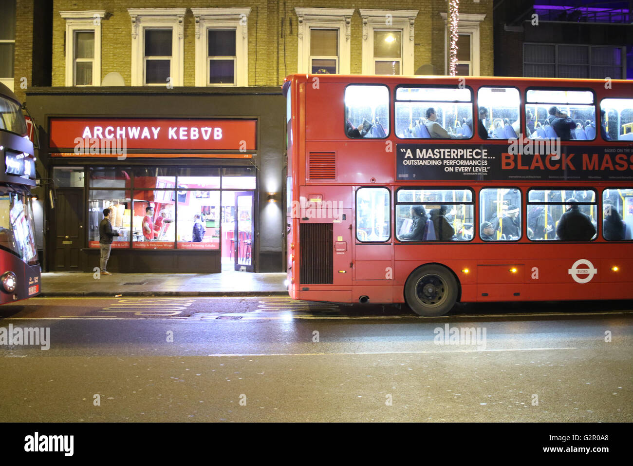 Buses at a stop on the Archway road outside a Kebab shop Stock Photo