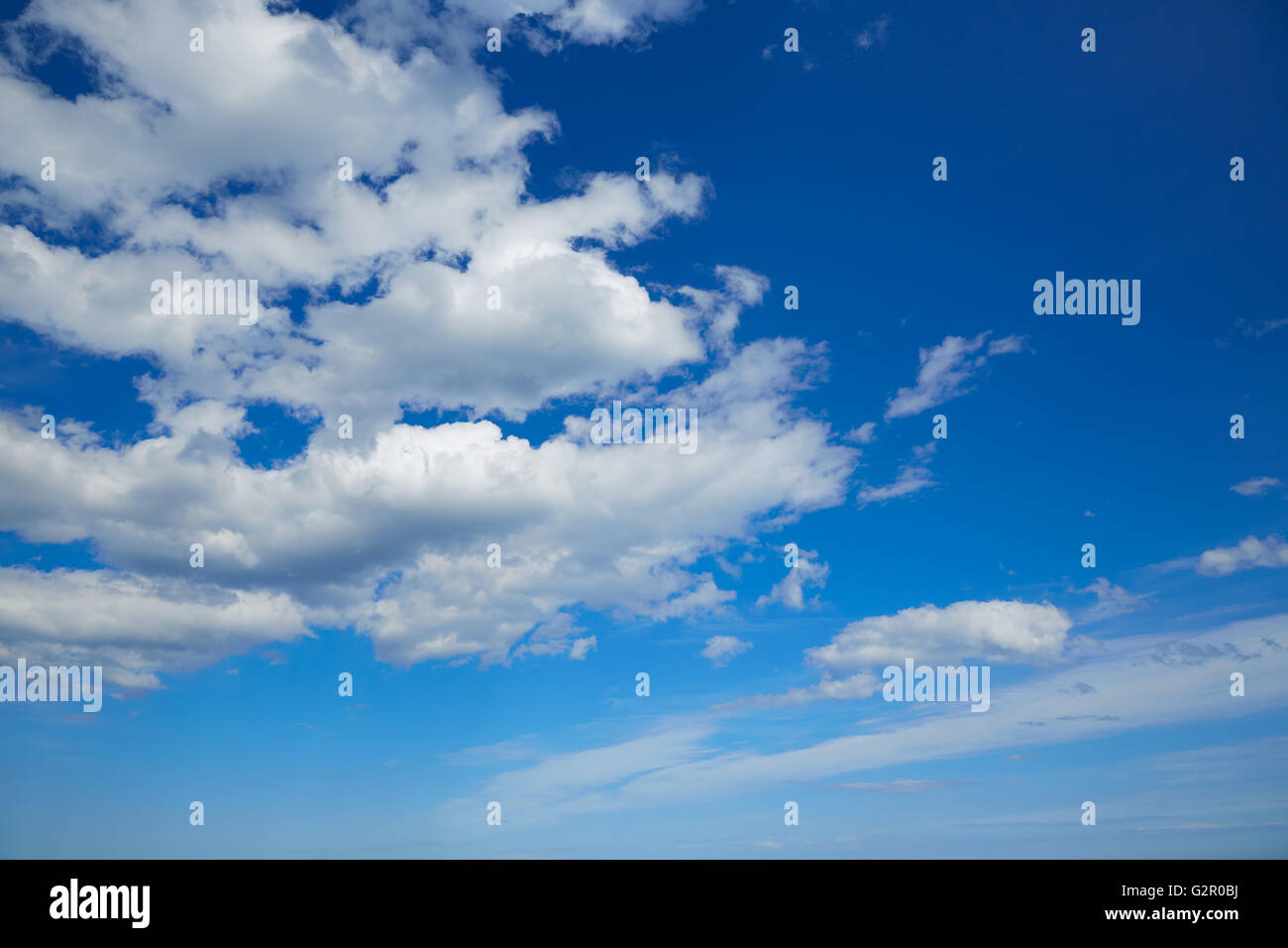 Blue summer sky in Mediterranean sea with white clouds Stock Photo