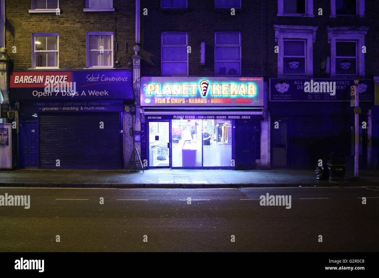 Shop frontages of a kebab shop and alcohol shop Stock Photo