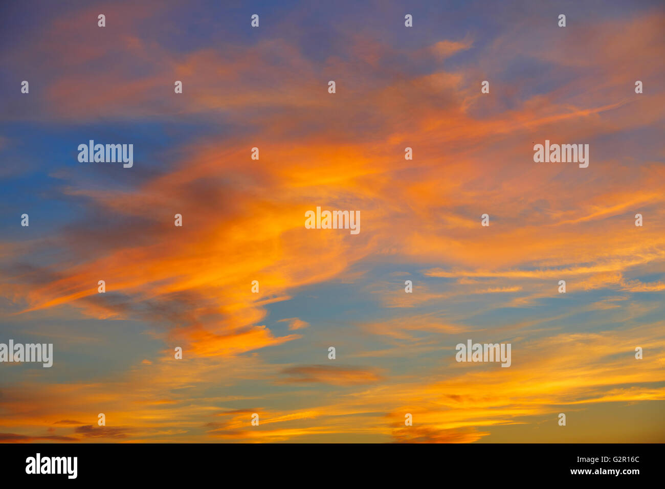 Sunset orange clouds in a blue sky at dusk Stock Photo - Alamy