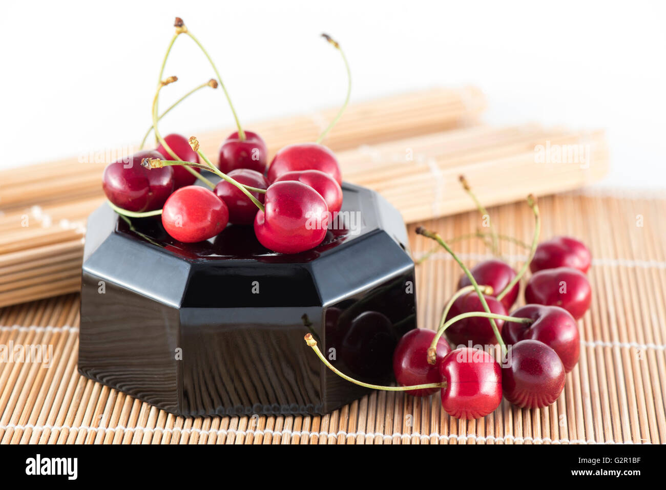 Sweet cherries group on bamboo Stock Photo