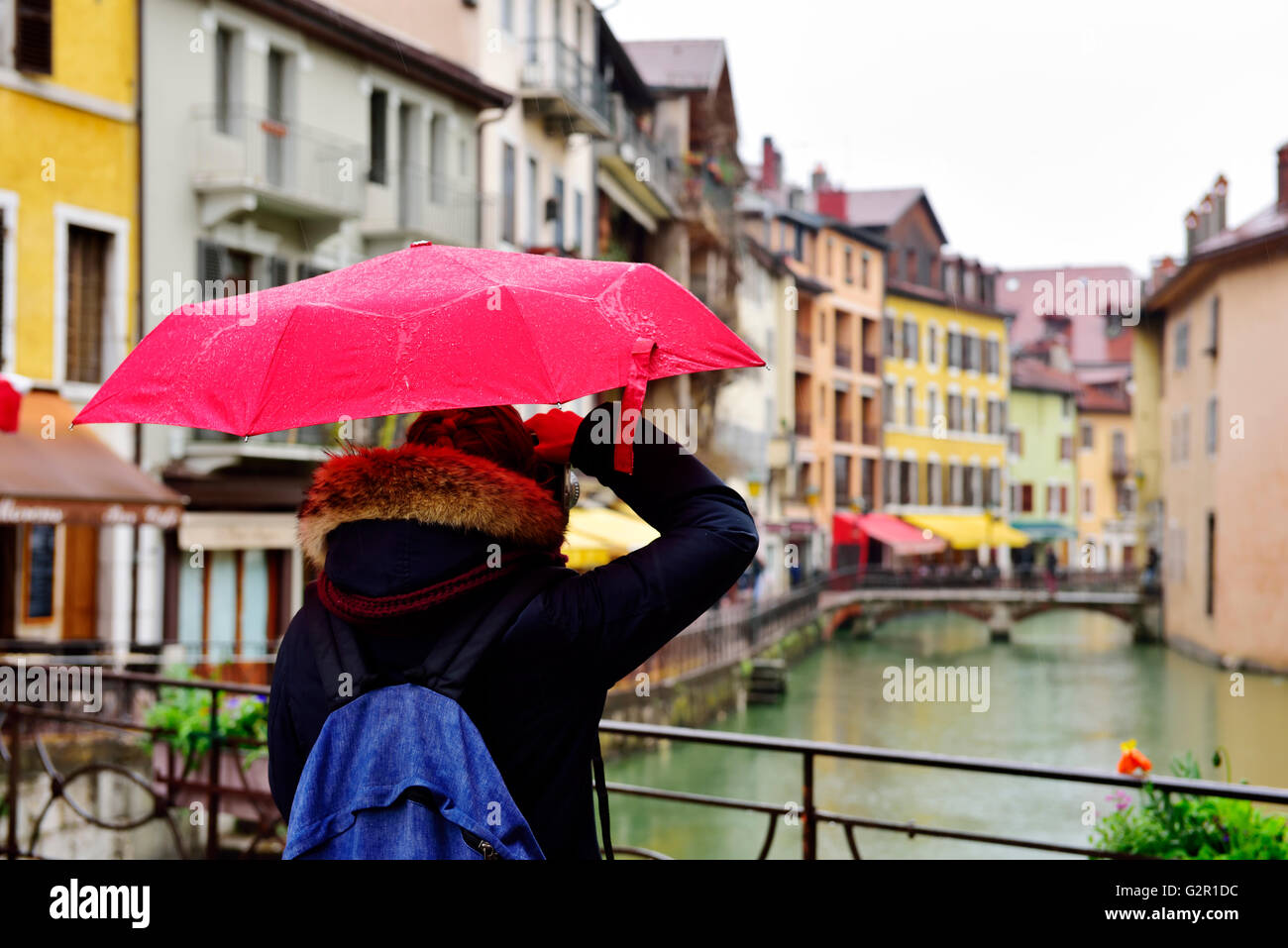 Person with red umbrella looking over river Le Thiou and bridges in the rain  Annecy, France Stock Photo - Alamy