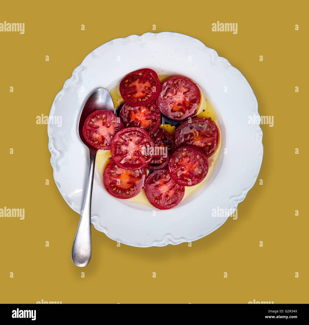 sliced tomatoes on plate Stock Photo