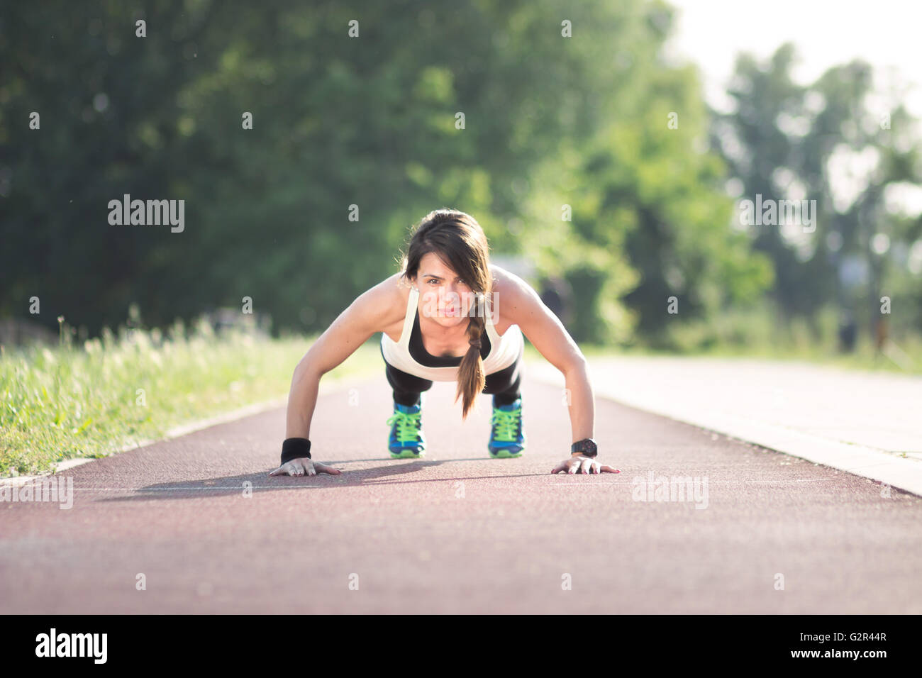 Girl push-up, outdoors, track. Stock Photo