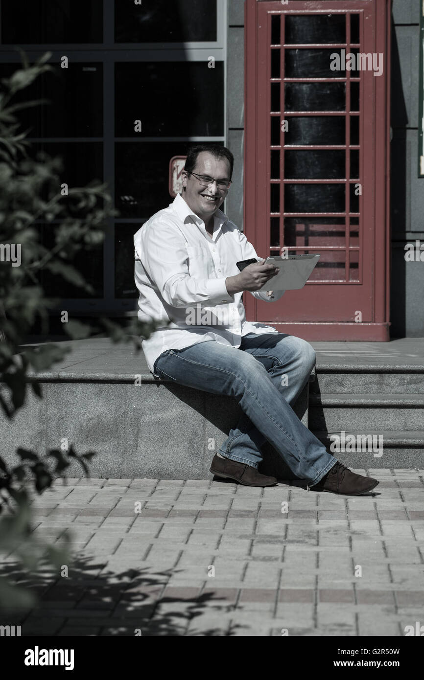 Man Using Red Telephone Business man using mobile phone red classic English telephone box ...