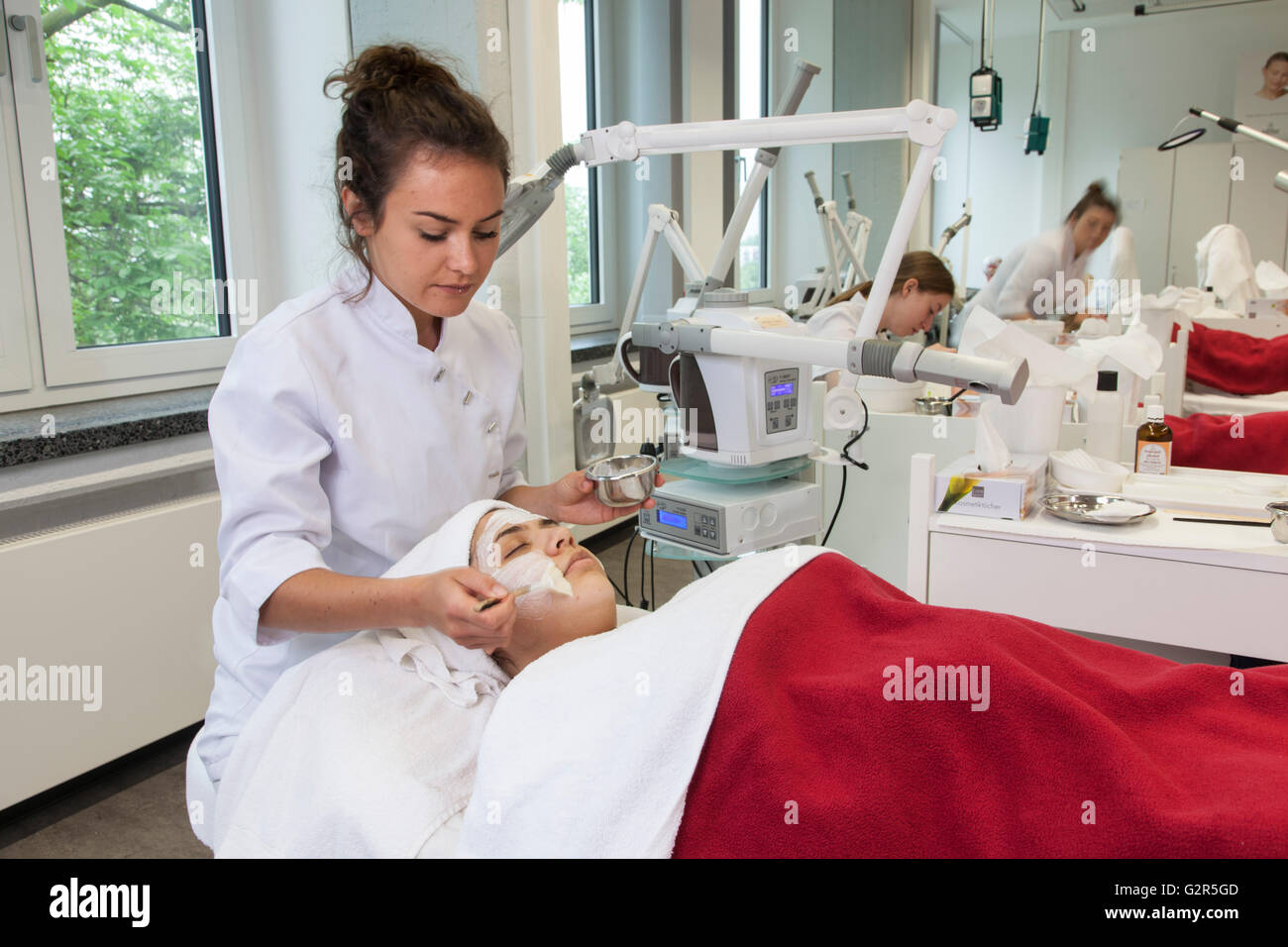 Beautician at work in a cosmetics institute Stock Photo