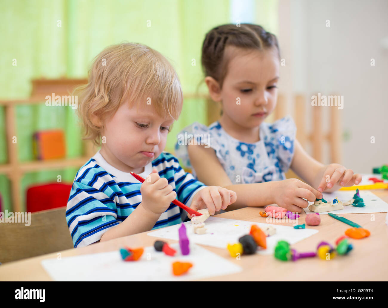 Kids or children creating arts and crafts in kindergarten Stock Photo