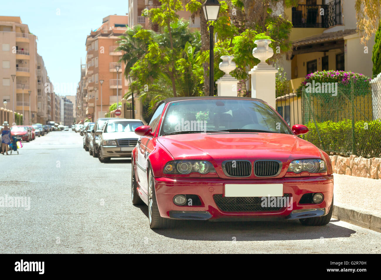 TORREVIEJA, SPAIN - SEPTEMBER 13, 2014: Red modern coupe-car BMW M3 series on sunny street, Calle Jacinto Benavente, Torrevieja Stock Photo