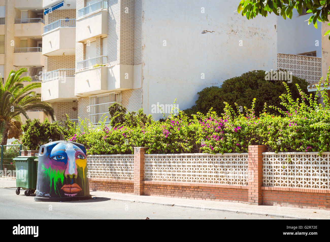 Art-decorated trashcan on sunny street, Streetart graffiti, Av Doctor Mariano Ruiz Canovas, Torrevieja, Valencia, Spain Stock Photo
