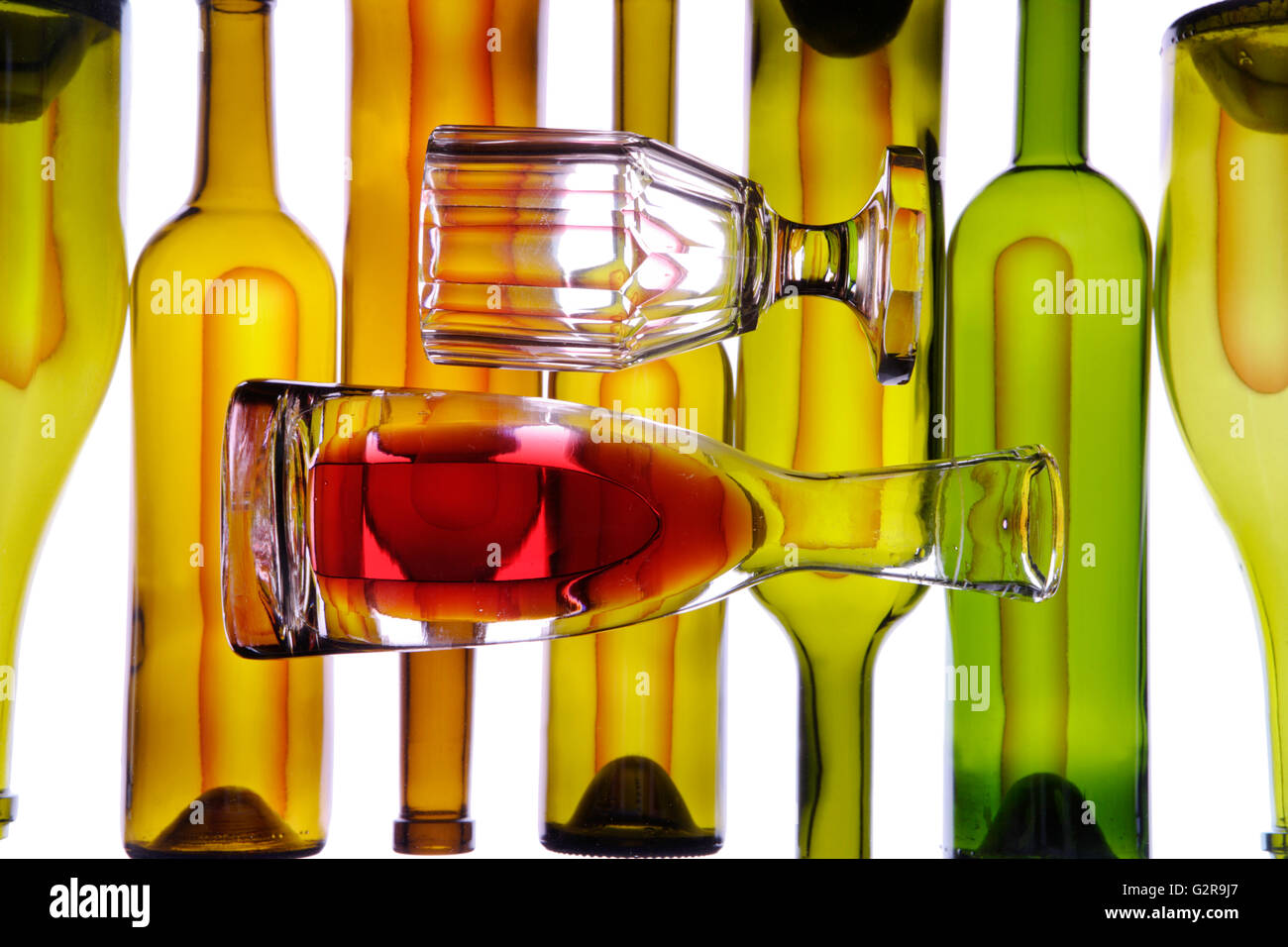 Carafe and wine glass in front of wine bottles Stock Photo