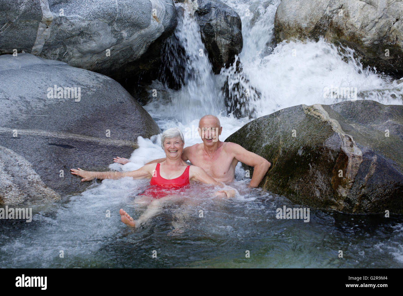 Couple, 59 and 68 years, bathing in the mountain river of Torrente Codera, Valle dei Ratti, Val dei Ratti, Lombardy, Italy Stock Photo