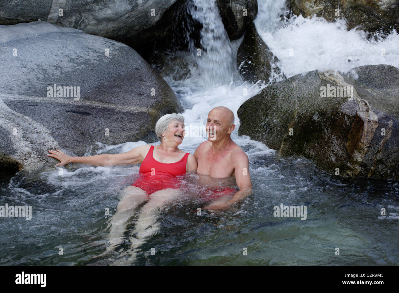 Couple, 59 and 68 years, bathing in the mountain river of Torrente Codera, Valle dei Ratti, Val dei Ratti, Lombardy, Italy Stock Photo