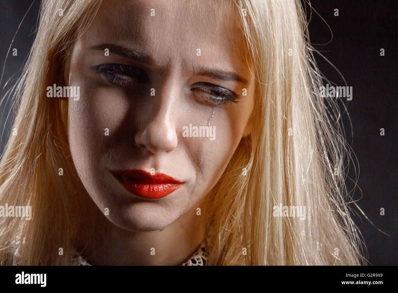 sad woman crying on black background Stock Photo - Alamy