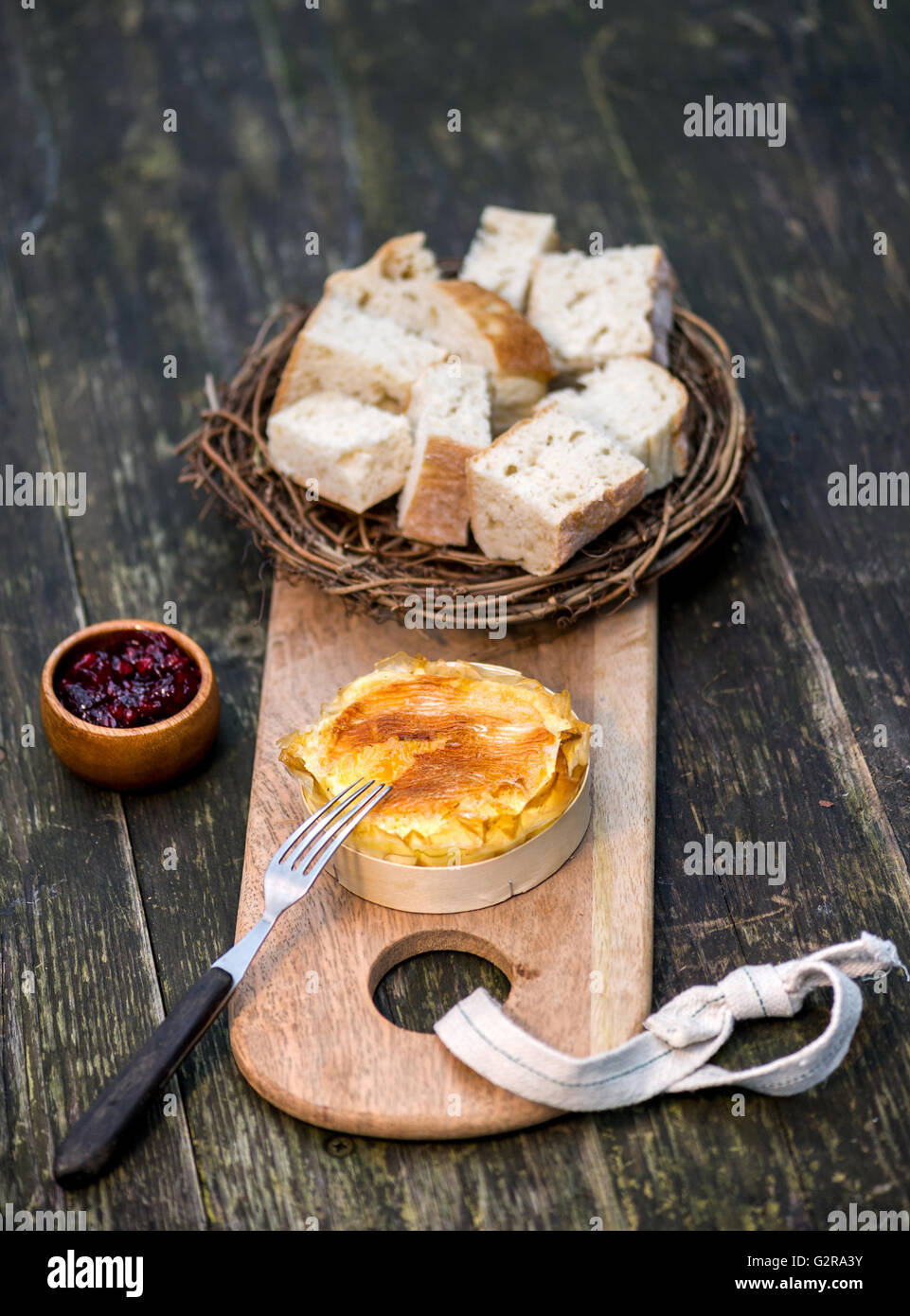 Camembert, served with a bread basket and cranberries Stock Photo