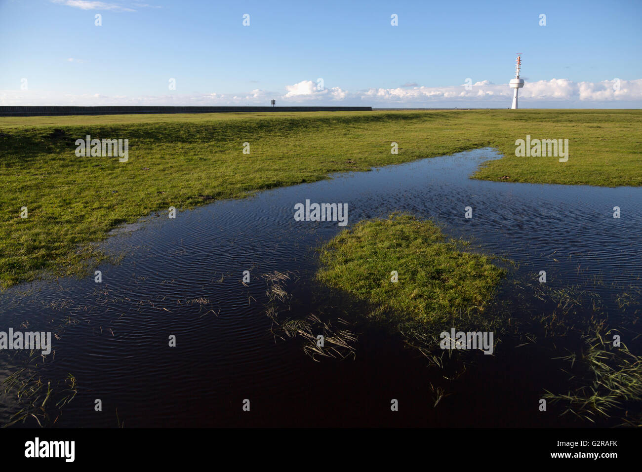 20.09.2015, Neuwerk, Hamburg, Germany - Meadows and Entwaesserungsgraben on the island Neuwerk in the Wadden Sea, right Radarturm the Kuestenradarkette. They created the radar image of the German Bight. Neuwerk you can walk around in two hours on foot, has about 40 inhabitants and belongs to Hamburg. / The small Iceland Neuwerk lies in the mudflats of the North Sea, has about 40 inhabitants and belongs to the region of Hamburg. Radar tower, one of a chain of towers search Which build the radar display of the German Bay. 00A150920D218CAROEX.JPG - NOT for SALE in G E R M A N Y, A U S T R I A, S  Stock Photo