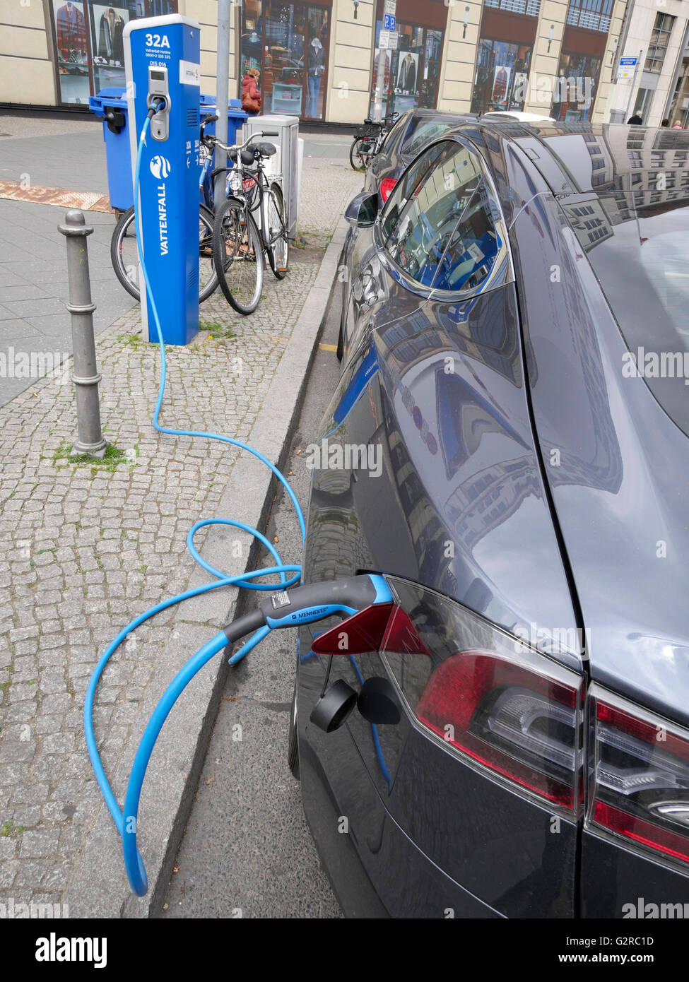 Modern car at an electric charging station on roadsiide charging the batteries Berlin, Germany