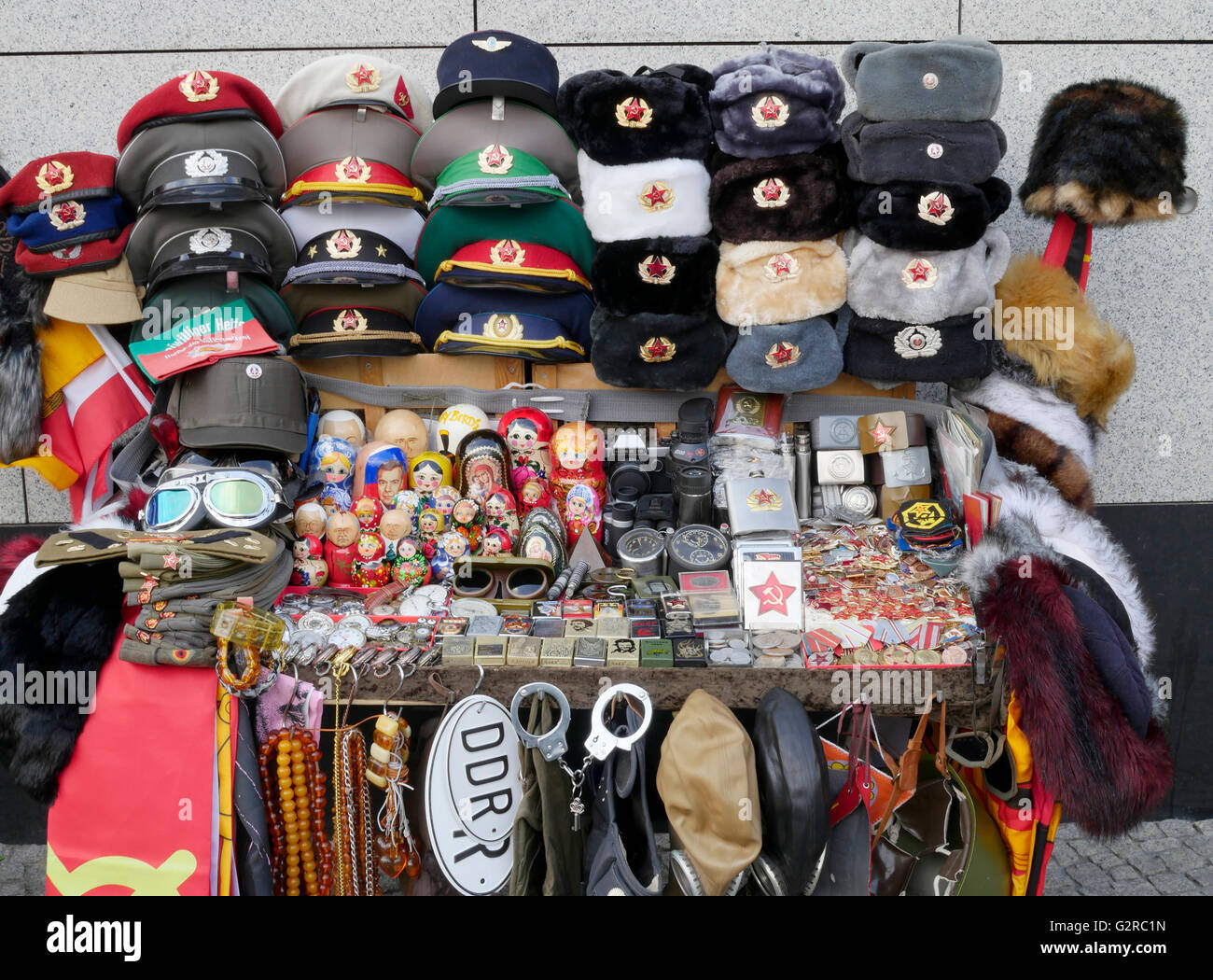Tourist street stall selling Berlin Souvenirs including East German and Russian memorabilia, at checkpoint Charlie, Berlin, Germany Stock Photo