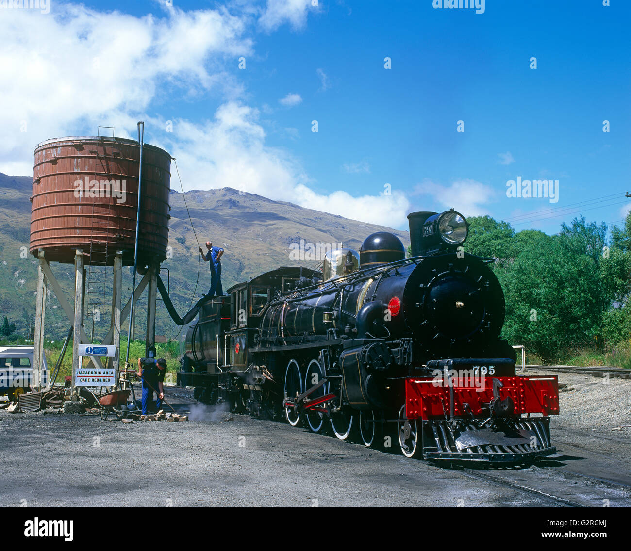 A steam train having maintenance done to it. Stock Photo
