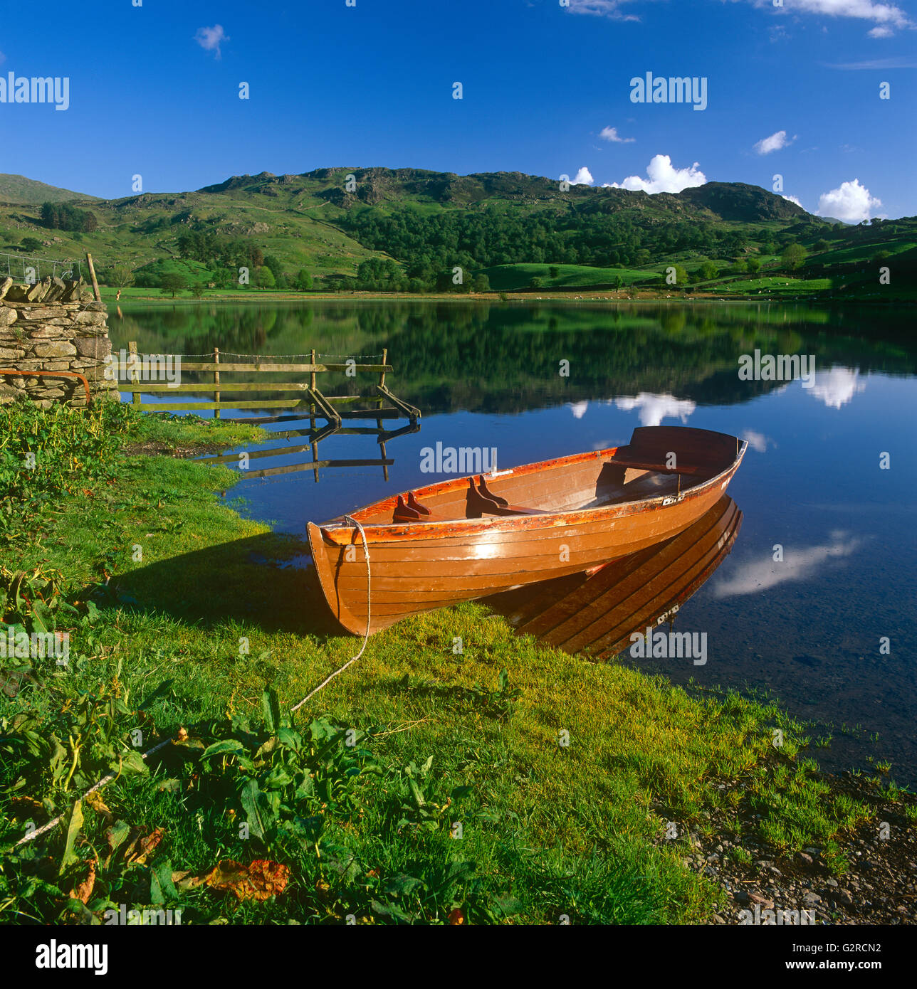 A rowing boat docked up, outside. Stock Photo