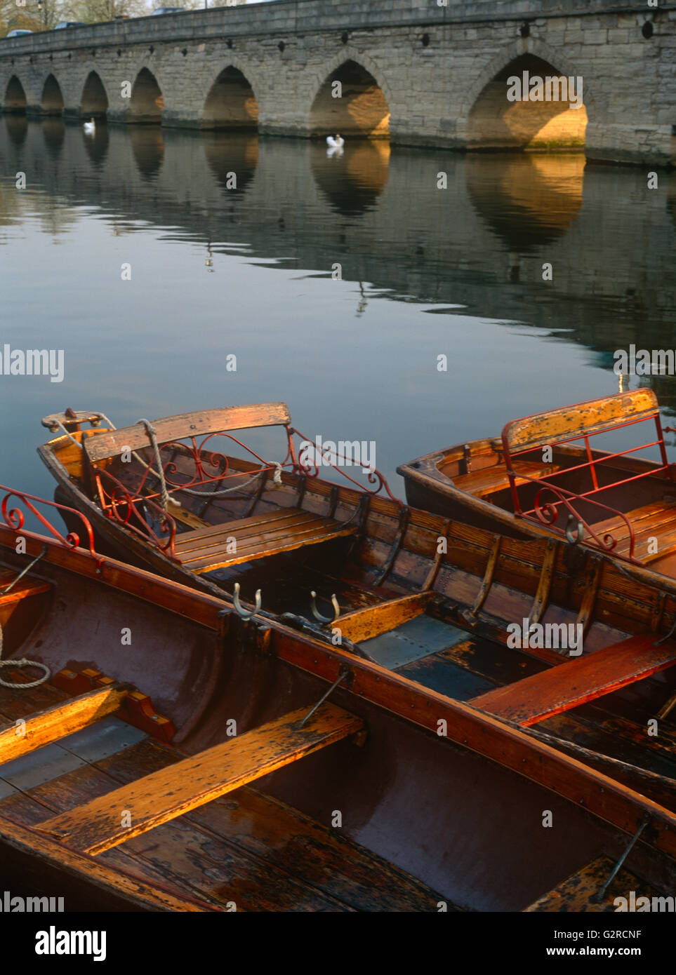 Old wooden boats docked up on the river Stock Photo