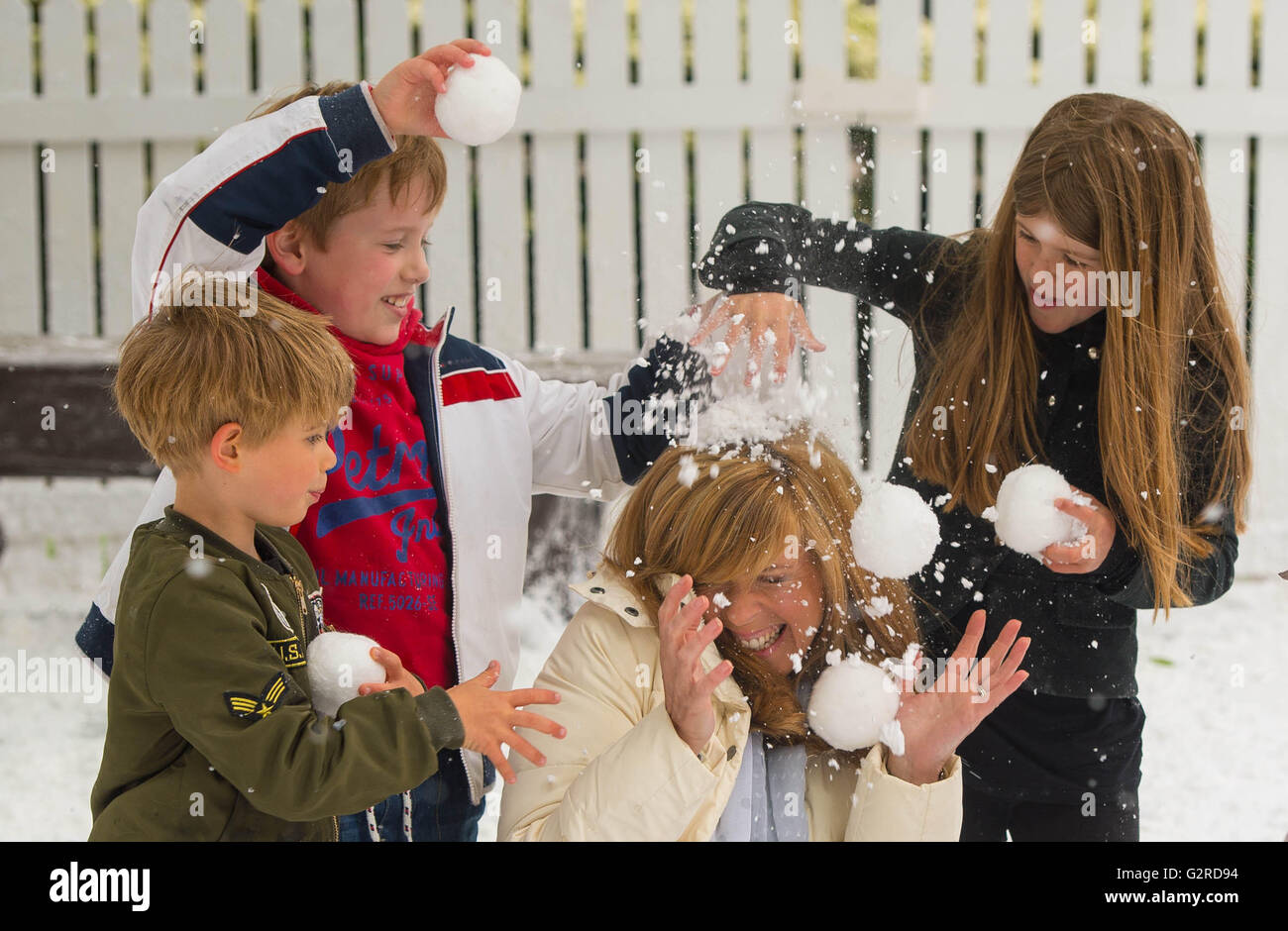 EDITORIAL USE ONLY Kate Garraway and (left to right) son Billy Draper, godson Monty White, and daughter Darcey Draper play in the snow at London's Cavendish Square to celebrate Disney On Ice presents Frozen coming to the UK. Stock Photo