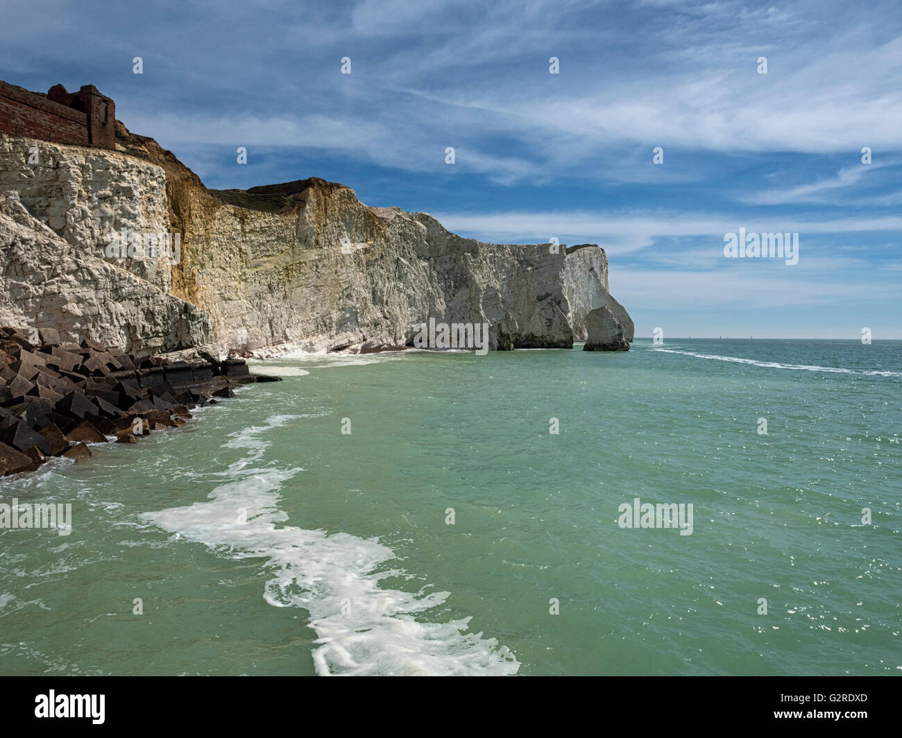 Crumbling chalk cliffs of the Sussex Downs tower above the beach at Seaford on the south coast of England, UK Stock Photo