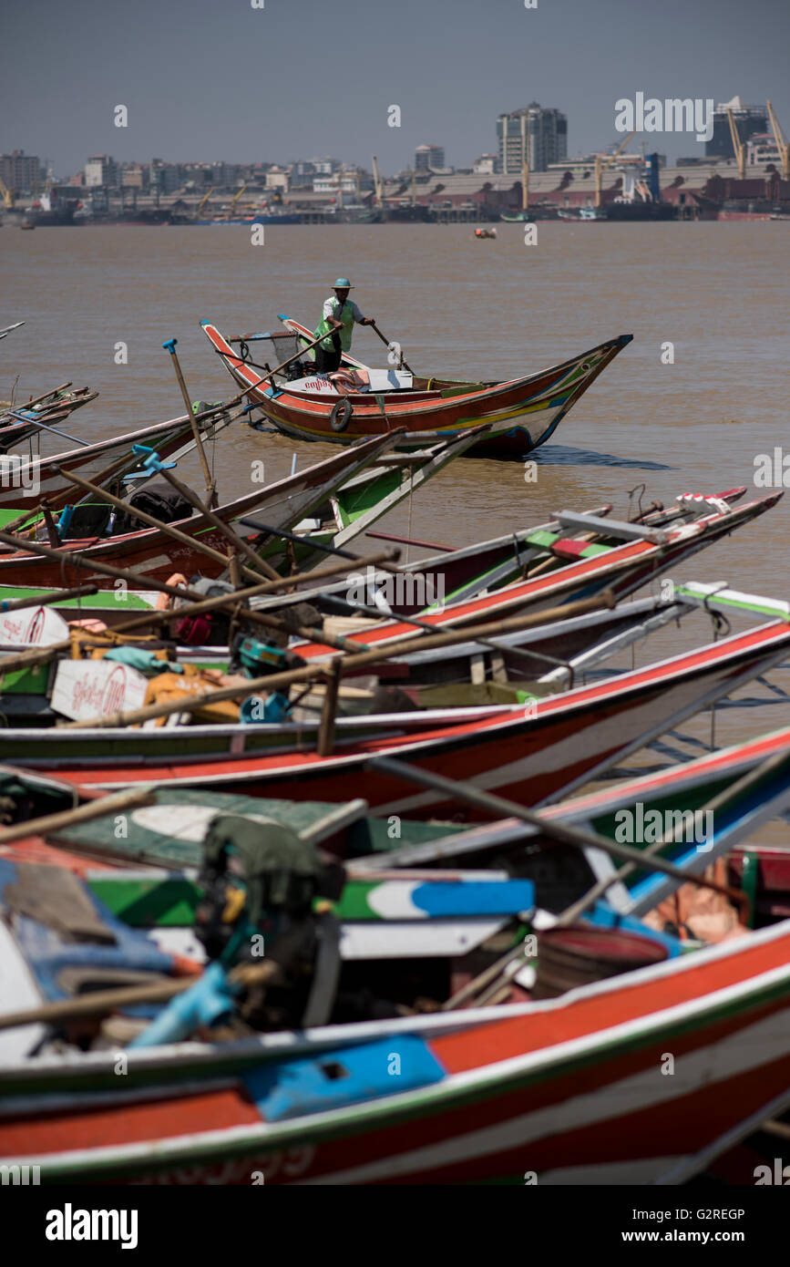 Long tail boats moored at the Yangon River shore in Dala, Yangon, Myanmar. Stock Photo
