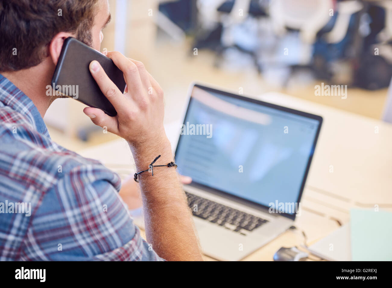 shot of man talking on the phone from behind him Stock Photo