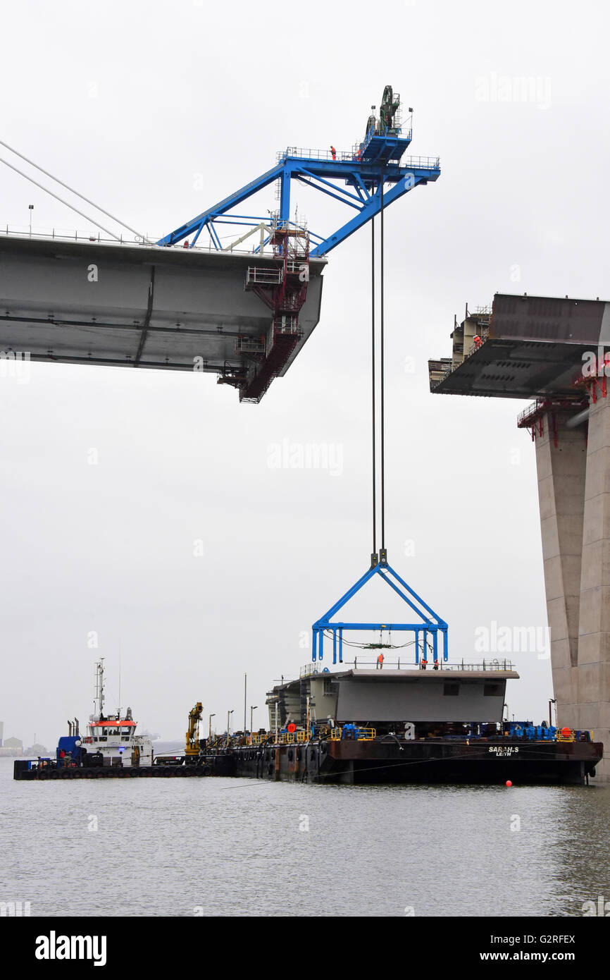 A crane prepares to lift the final deck section connecting the north