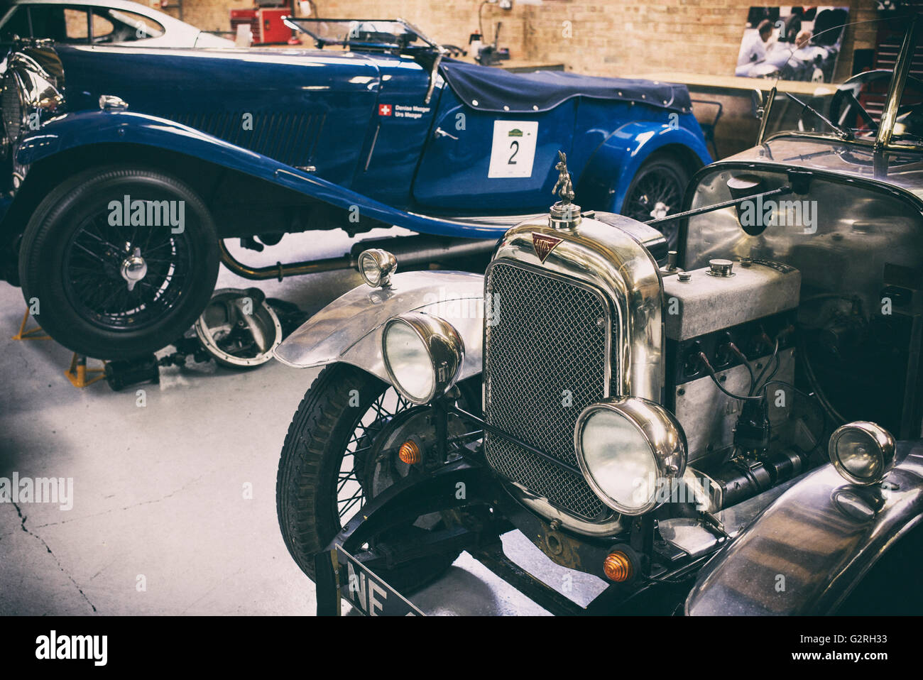 Vintage Alvis car in a workshop at Bicester Heritage Centre. Oxfordshire, England. Vintage filter applied Stock Photo