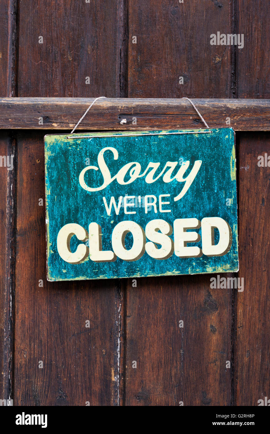 Sorry were closed sign on a shop wooden door. Cotswolds, England Stock Photo