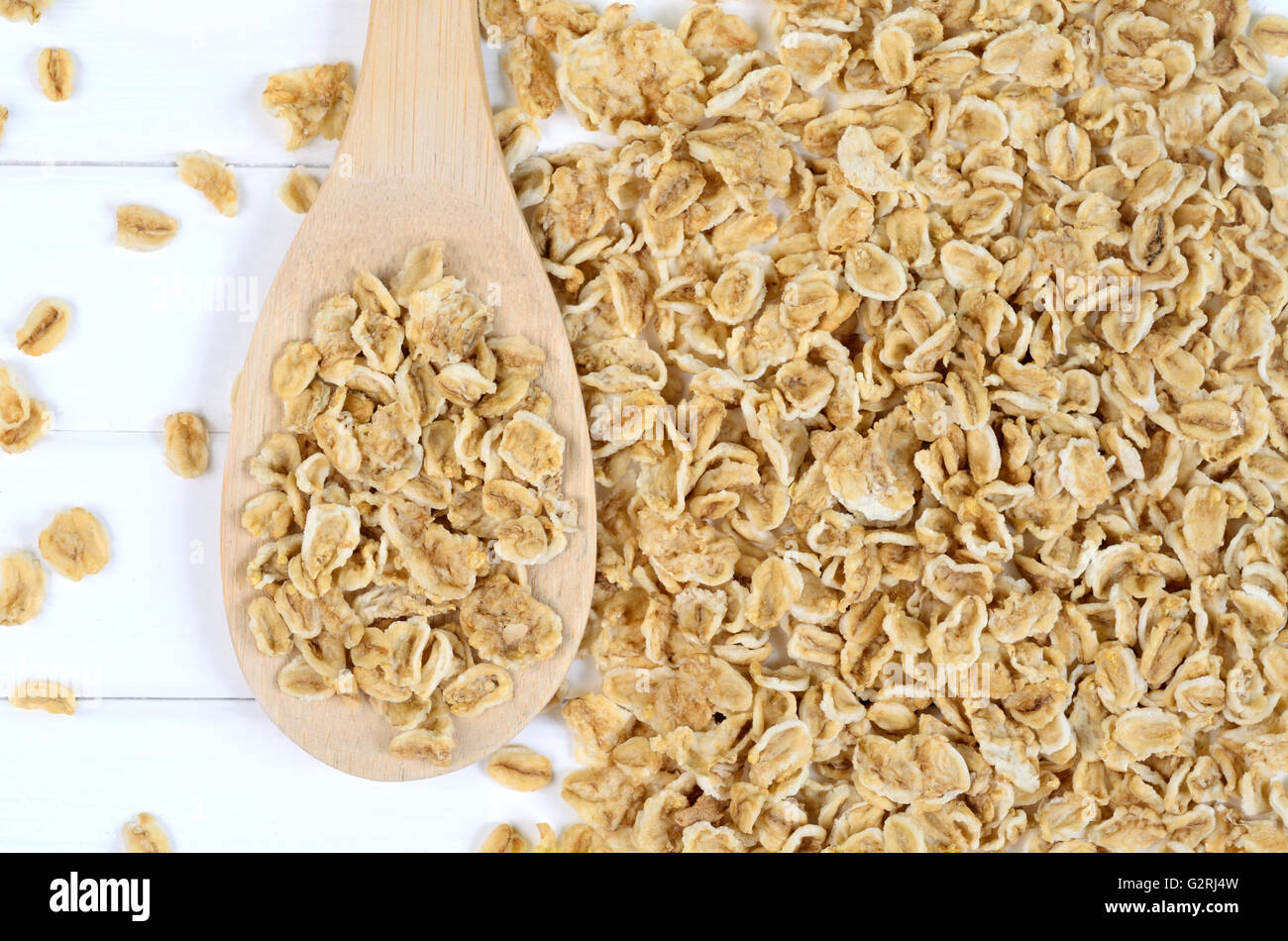 Wooden spoon with crispy oats on table Stock Photo