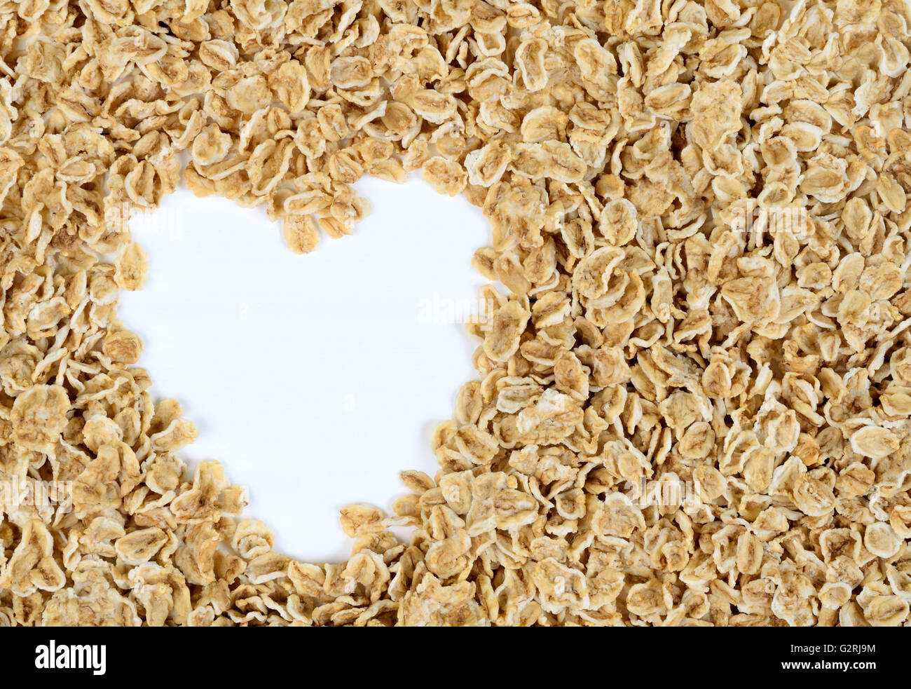 Heart shape of oats heap on table Stock Photo