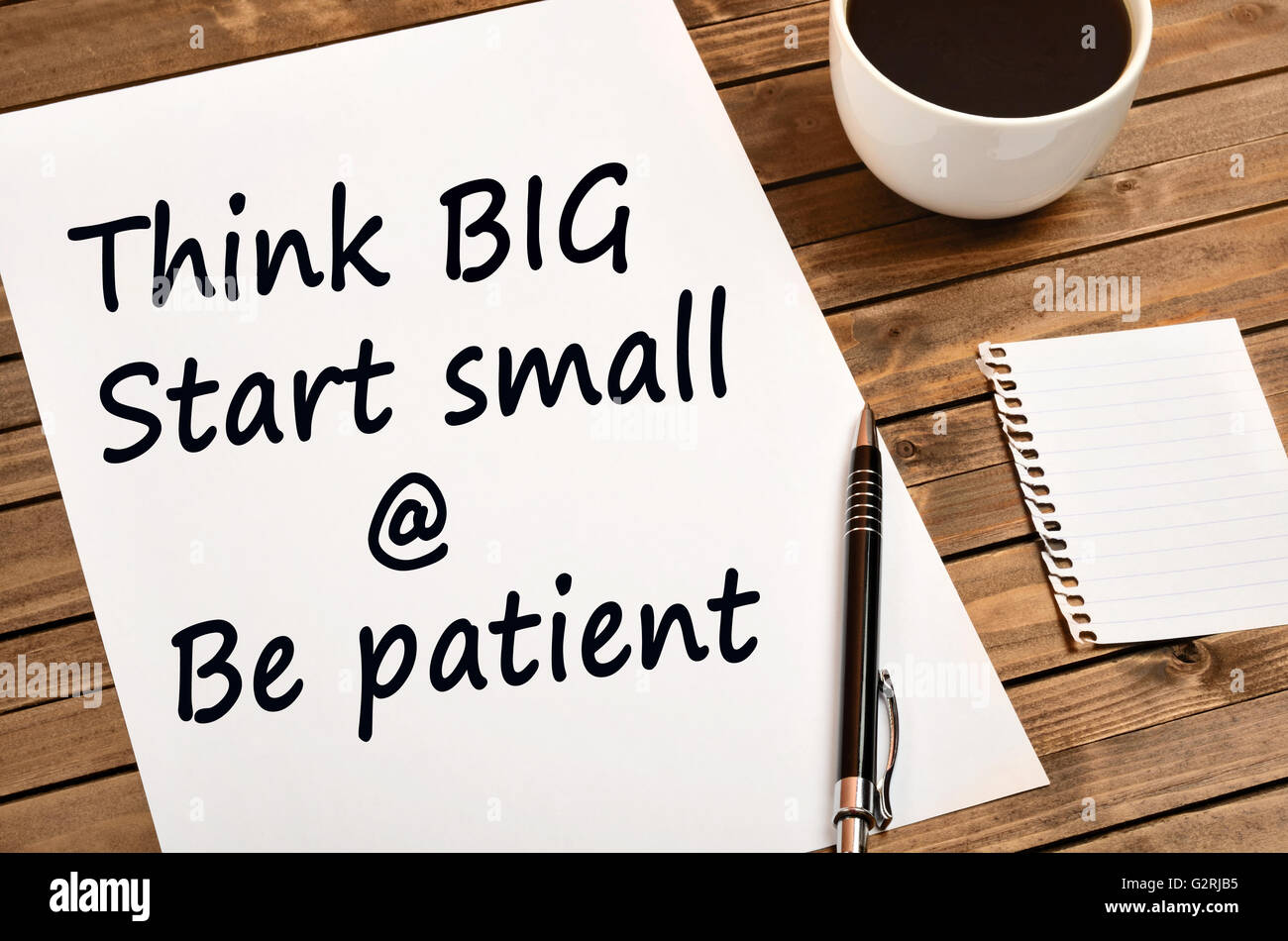 Words Think big Start small and Be patient on paper Stock Photo