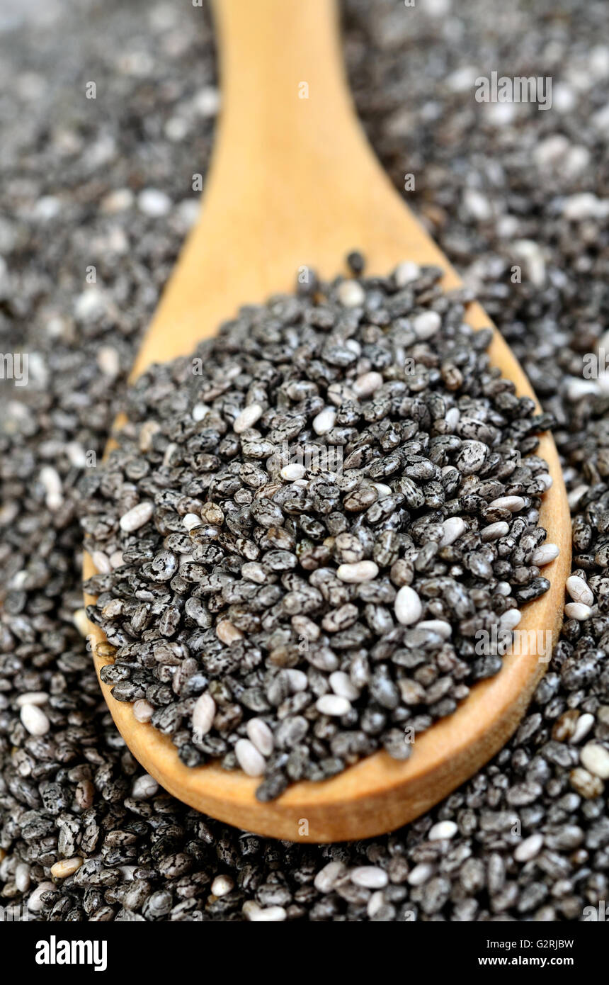 Organic dry chia seeds in a wooden spoon Stock Photo