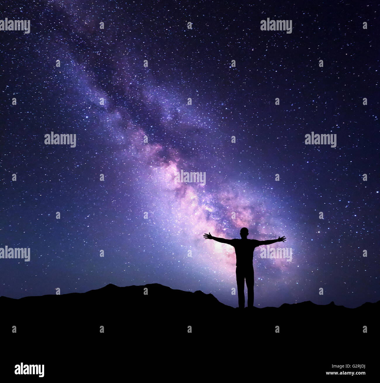 Night colorful landscape with Milky Way and silhouette of a standing ...