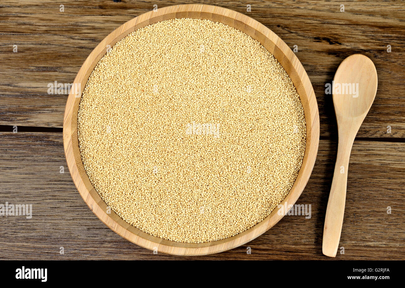 Amaranth seeds in a bamboo bowl on wooden table Stock Photo