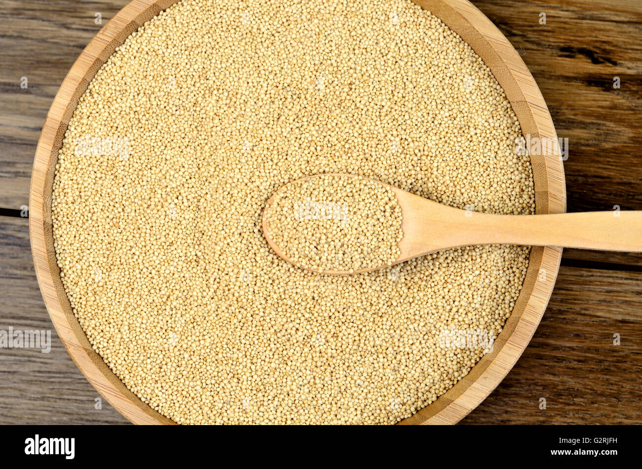 Healthy amaranth seeds in a bamboo bowl on wooden table Stock Photo