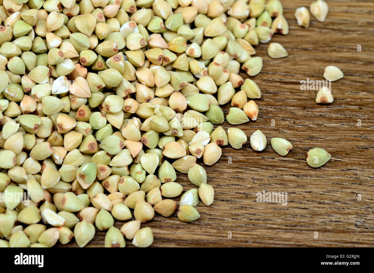 Green buckwheat on wooden table Stock Photo