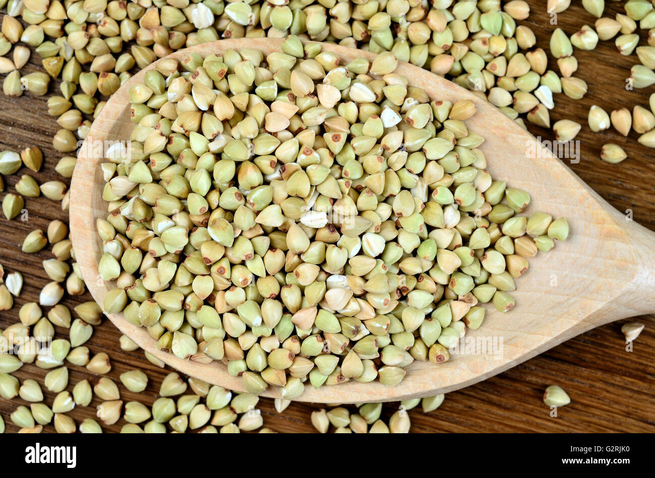 Healthy green buckwheat in a wooden spoon Stock Photo