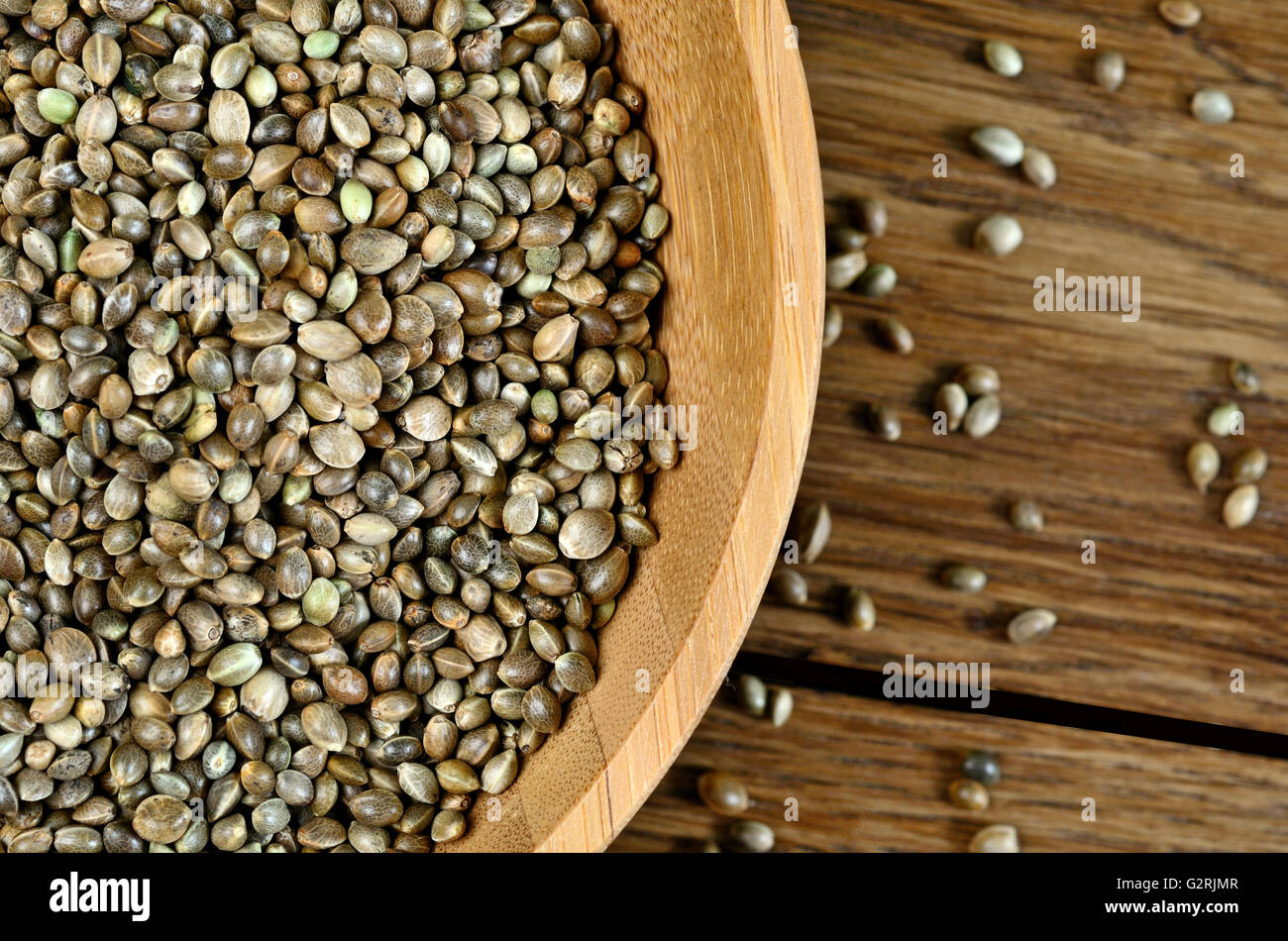 Bamboo bowl with hemp seeds on wooden table Stock Photo